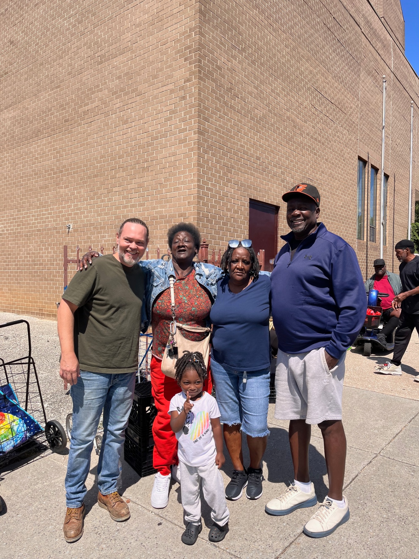 Community members and volunteers posing together at distribution site